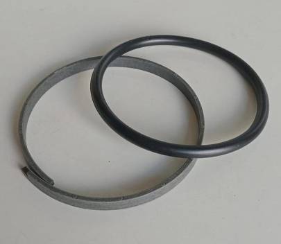 Two-piece seal, contains a piston ring and an expander, which prevents oil transfer between the cylinder rod end and the cap end.